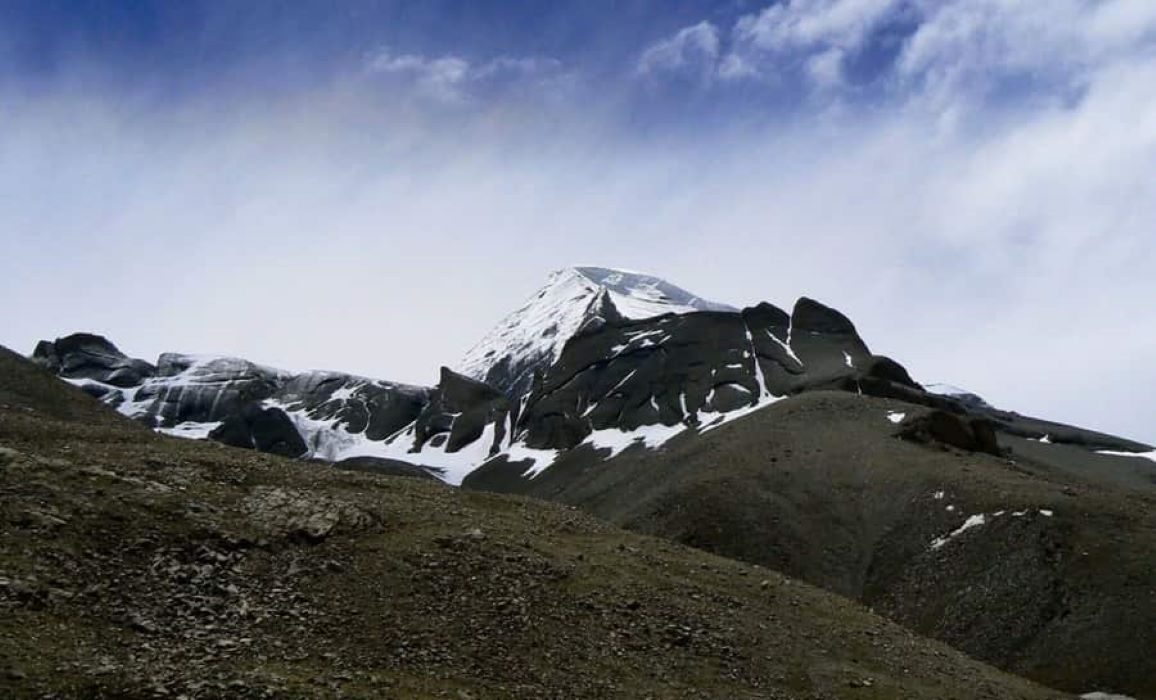 Snowy Mount Kailash under clear sky during spiritual trek